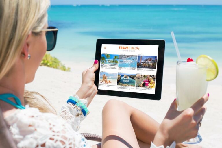 a woman holding a tablet on a beach