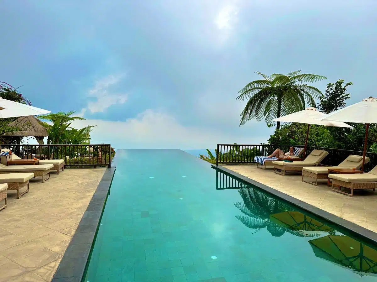 Swimmer In The Upper Infinity Pool With Panoramic North Bali Jungle And Mountain Views At Munduk Moding Plantation