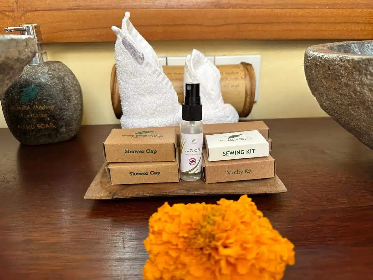 Complimentary Villa Amenities Including Branded Stone Soap, Bug Spray, Sewing Kit, And Vanity Kit With Marigold Flower At Munduk Moding Plantation