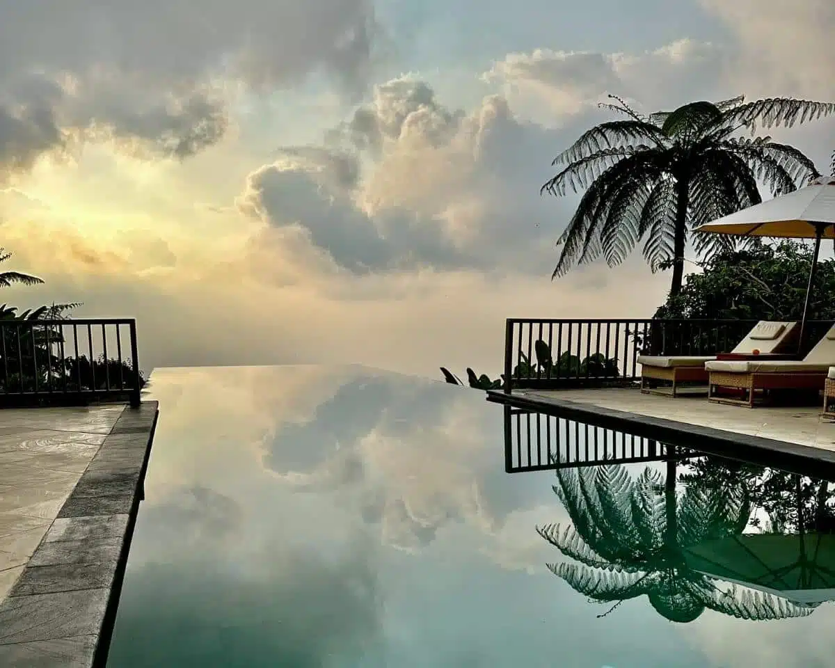 Sunrise View From The Upper Infinity Pool Terrace With Misty Rainforest Backdrop At Munduk Moding Plantation, North Bali