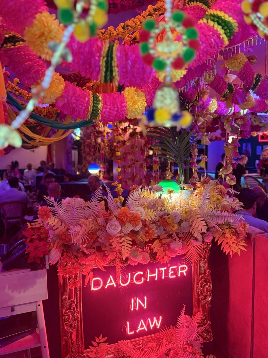 a sign with flowers and lights