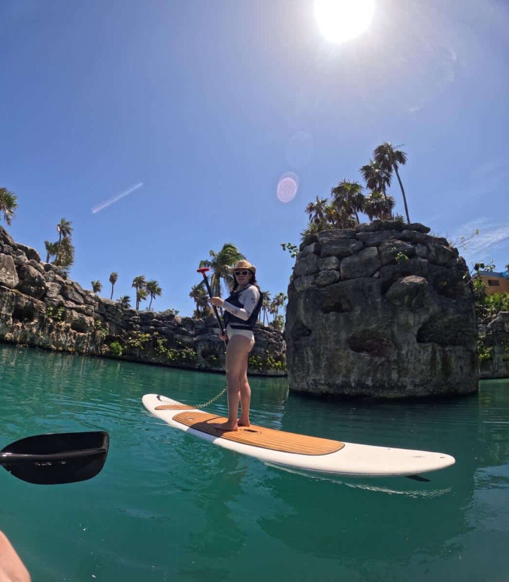 Woman Paddleboarding On The Turquoise Jungle River At Xcaret Arte All-Inclusive Resort Near Playa Del Carmen, Mexico