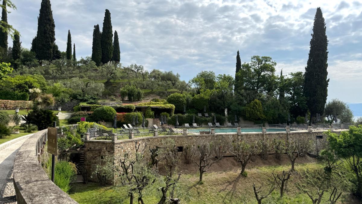 Outdoor Pool With Sun Loungers At Villa Del Sogno Set Among An Olive Grove, Cypress Trees, And Terraced Italian Gardens Above Lake Garda