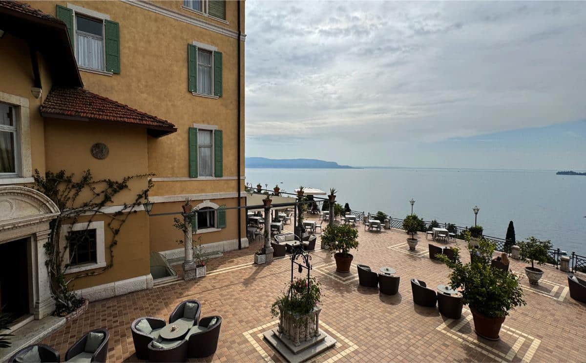 Expansive Lakeside Terrace At Villa Del Sogno With Potted Lemon Trees, Lounge Seating, And Panoramic Views Of Lake Garda, Italy