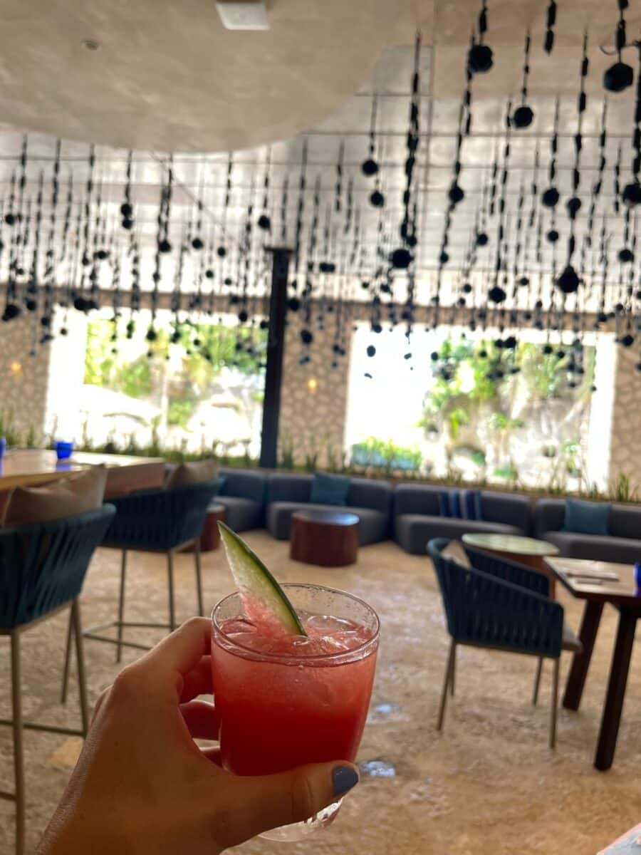 Specialty Cocktail At Arenal Restaurant At Xcaret Arte All-Inclusive Resort In Mexico With Open Airy Interior