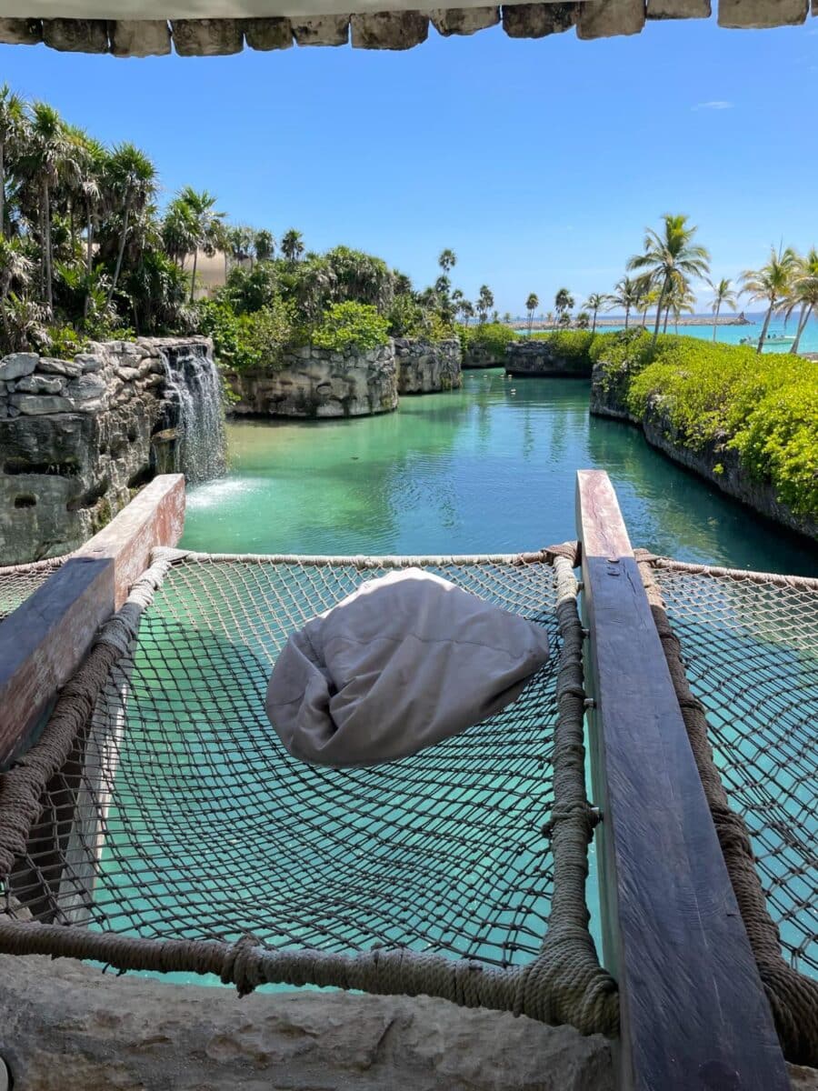 Hammock Overlooking The Turquoise Jungle River With Waterfall And Palm Trees At Xcaret Arte All-Inclusive Resort Mexico