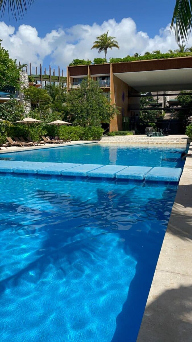 Main Pool At Xcaret Arte Adults-Only All-Inclusive Resort Surrounded By Tropical Gardens And Sun Loungers Near Playa Del Carmen