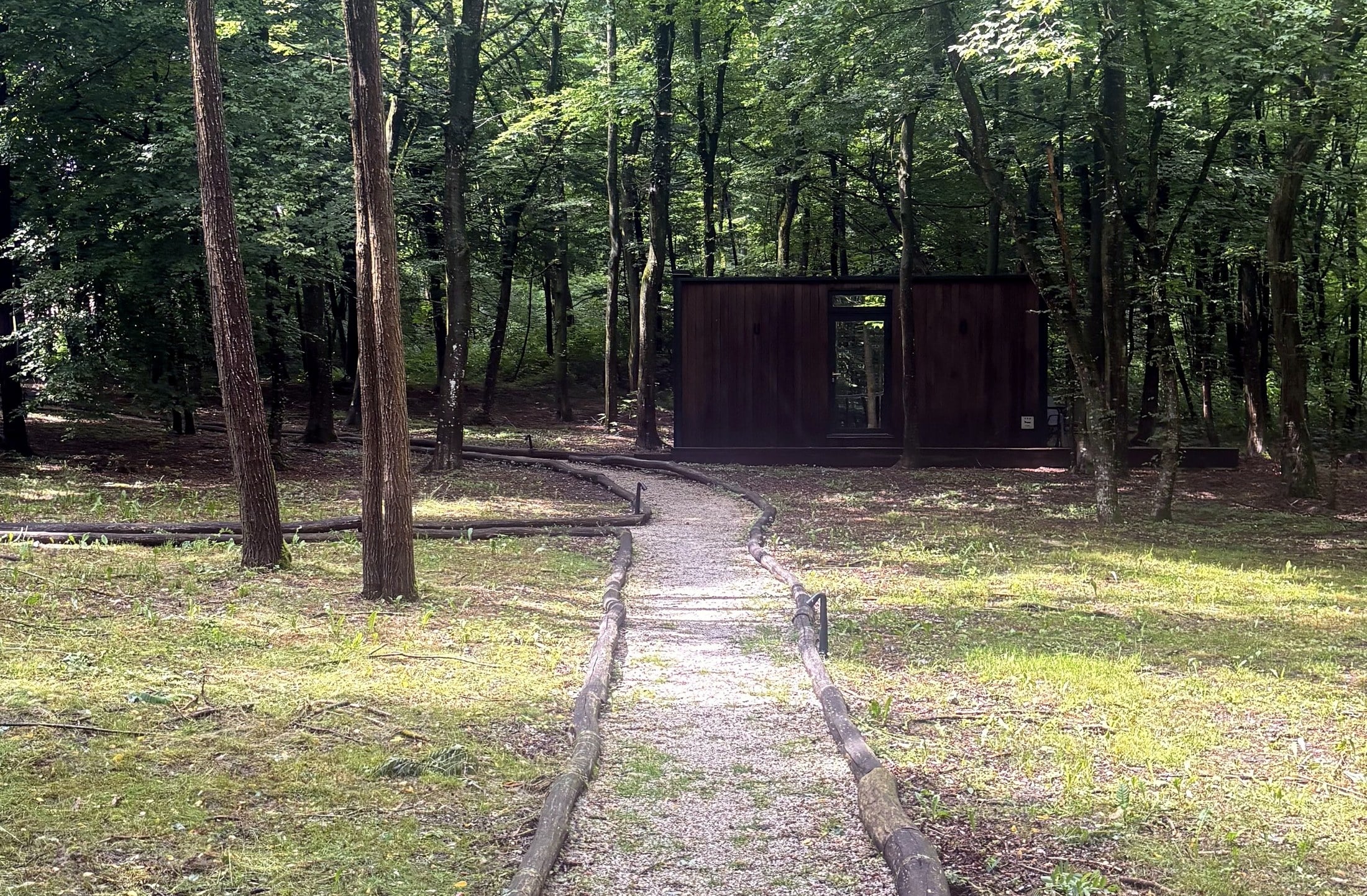 A Mala Vila Cabin At The End Of A Forest Path